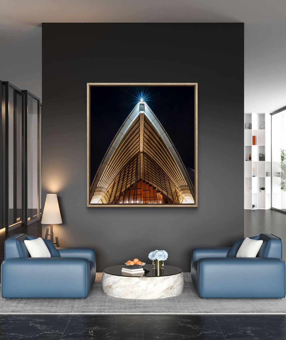 Framed vertical print of Sydney Opera House architecture at night displayed in a luxury living room.
