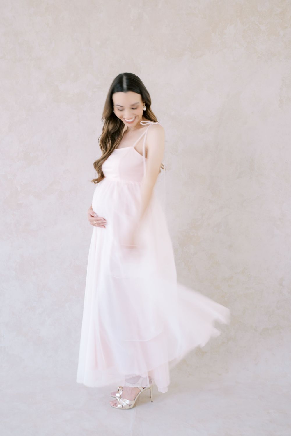 A series of ethereal portraits showing a figure in flowing white dress twirling against a light neutral background.