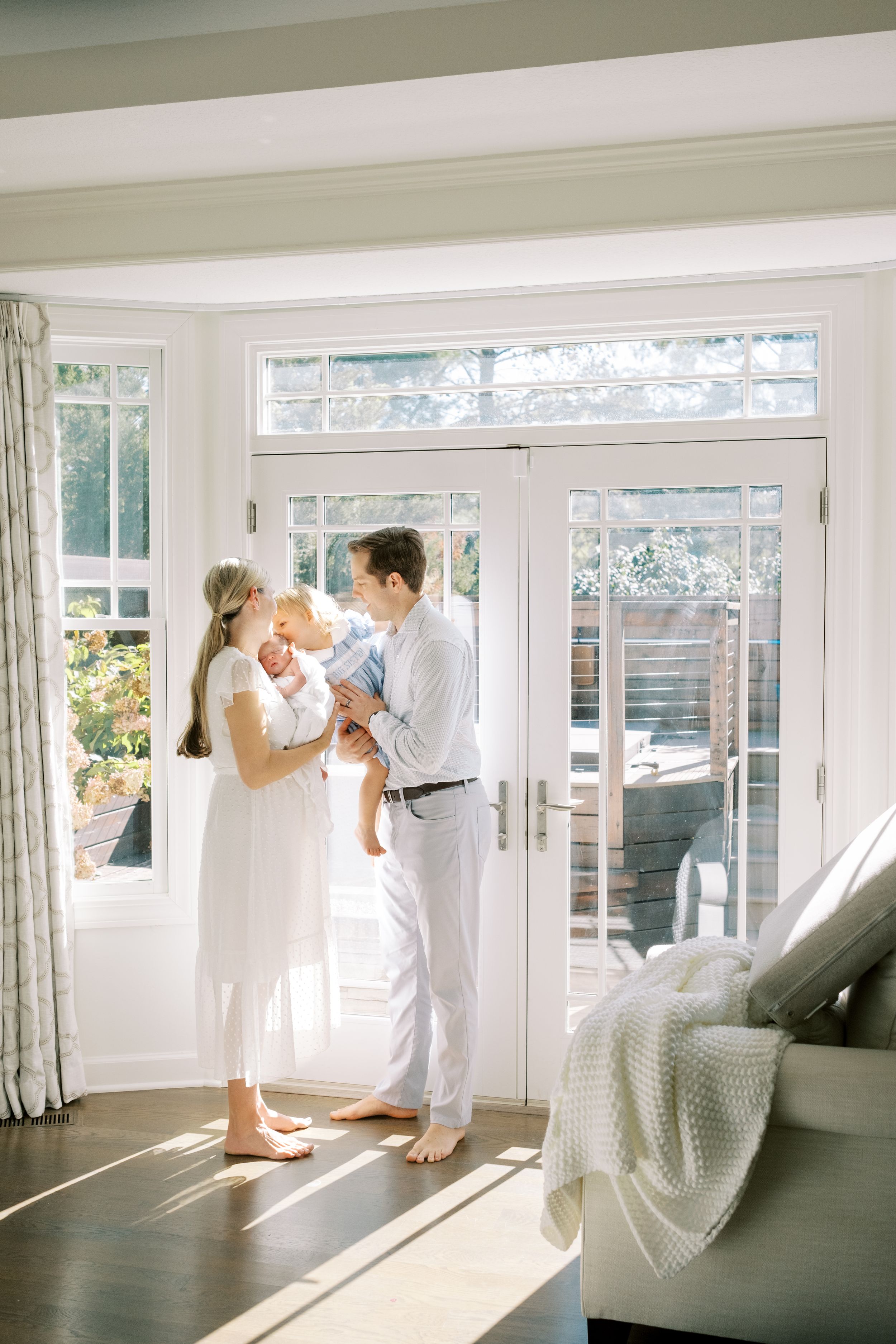 A series of romantic wedding photos showing a couple in white dancing and embracing in a bright sunlit room.