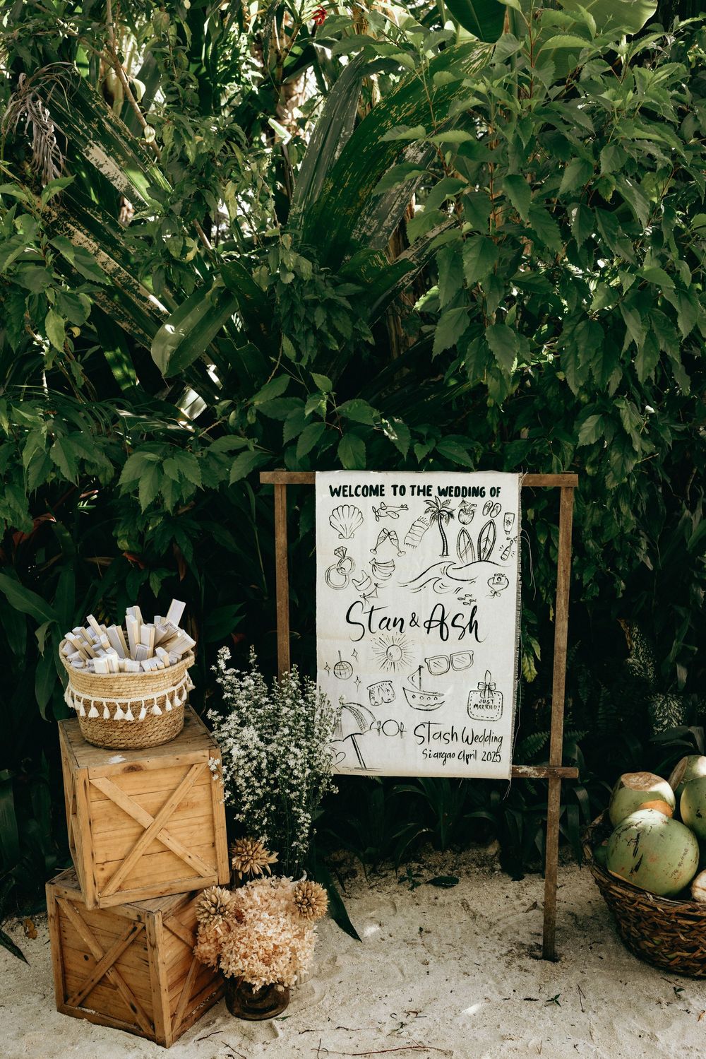 Rustic wooden crates and welcome sign display at a garden wedding.