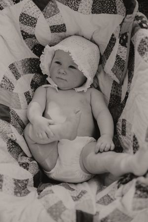Artistic black and white photo featuring a patchwork quilt pattern.