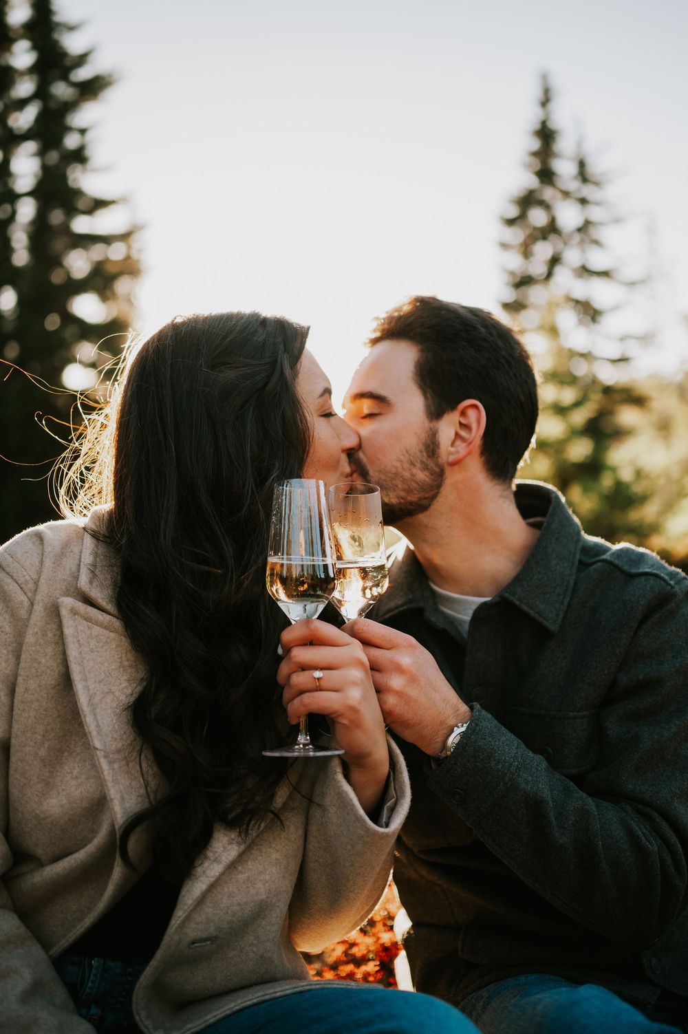 Engagement fall adventure photoshoot on Mt. Washington of couple kissing holding champagne glasses in Paradise Meadows Vancouver Island