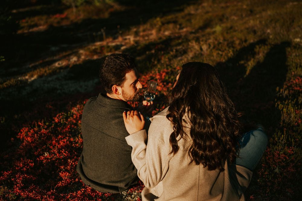 Engagement fall adventure photoshoot on Mt. Washington of couple snuggling with champagne in Paradise Meadows Vancouver Island