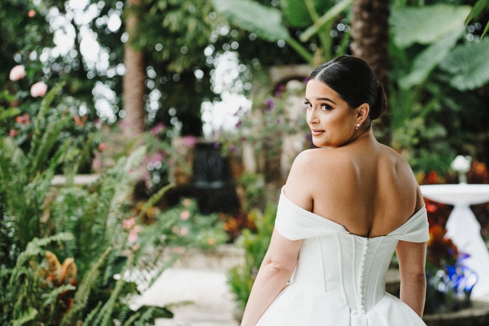 A garden wedding celebration with elegant white decor and natural greenery surroundings.