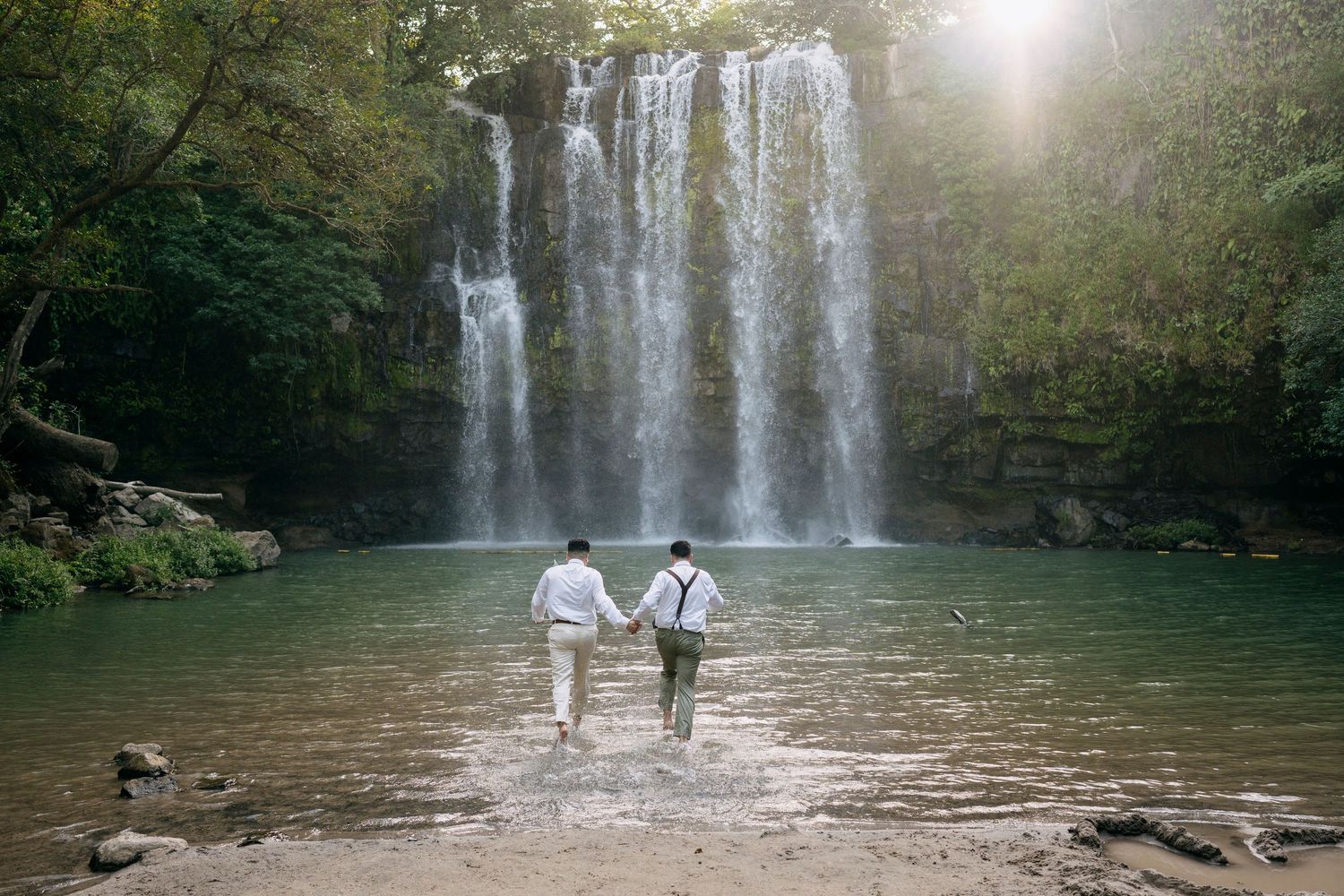 Elopement couple in front of Llanos de Cortés Waterfall in Costa Rica.