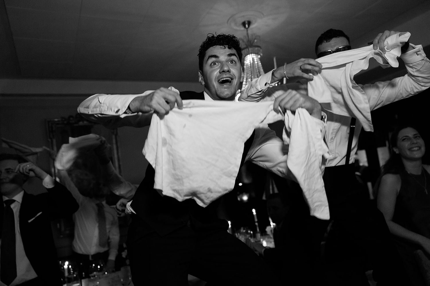 A sequence of black and white photos showing someone performing a martial arts move with a white gi uniform.