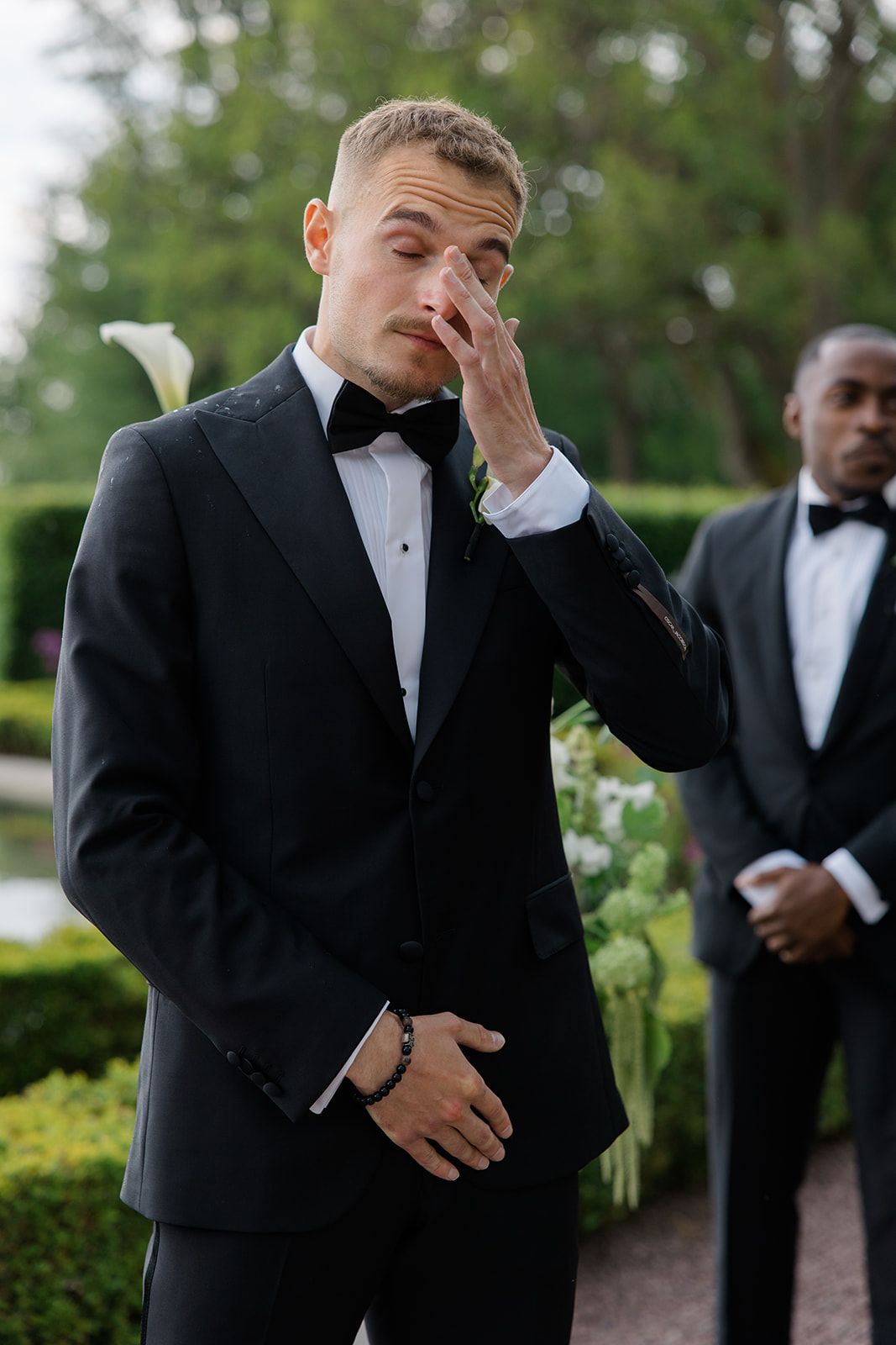A sequence of emotional moments shows a groom in a black tuxedo displaying various reactions during a wedding ceremony.