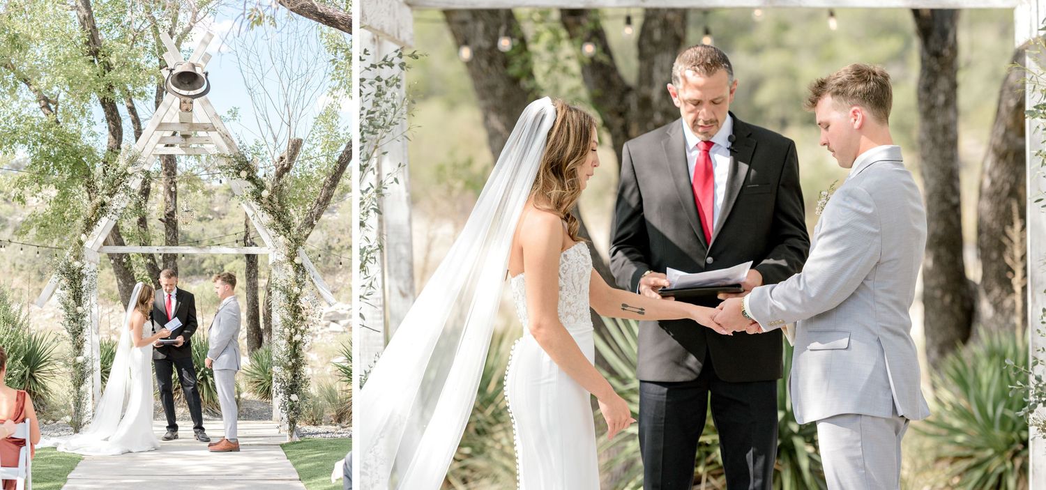 An outdoor wedding ceremony scene with a decorative white arch and trees in the background.