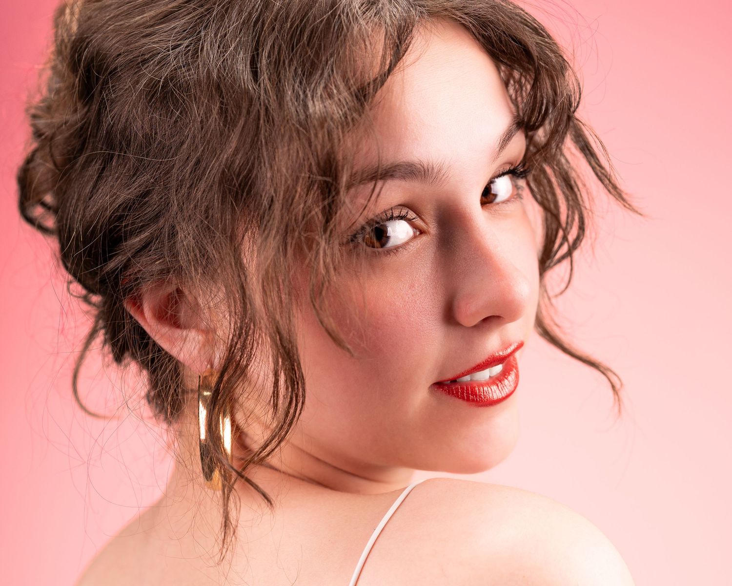 A series of profile portraits against a pink background showing different angles and expressions.