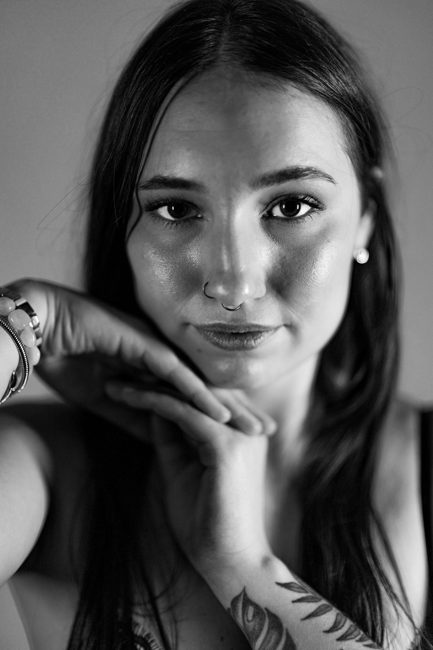 A black and white photo series showing different angles and expressions in a dramatic lighting style.
