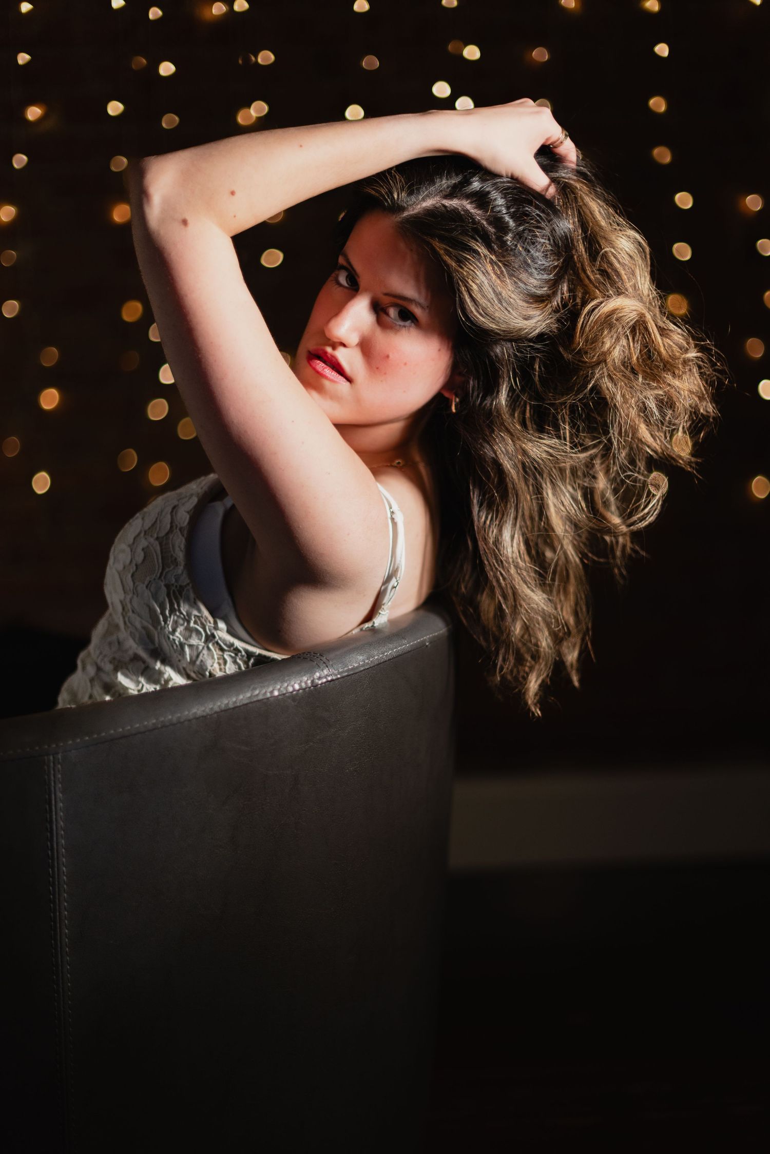 Artistic portrait series against dark background with bokeh lights showing graceful poses in dramatic lighting.
