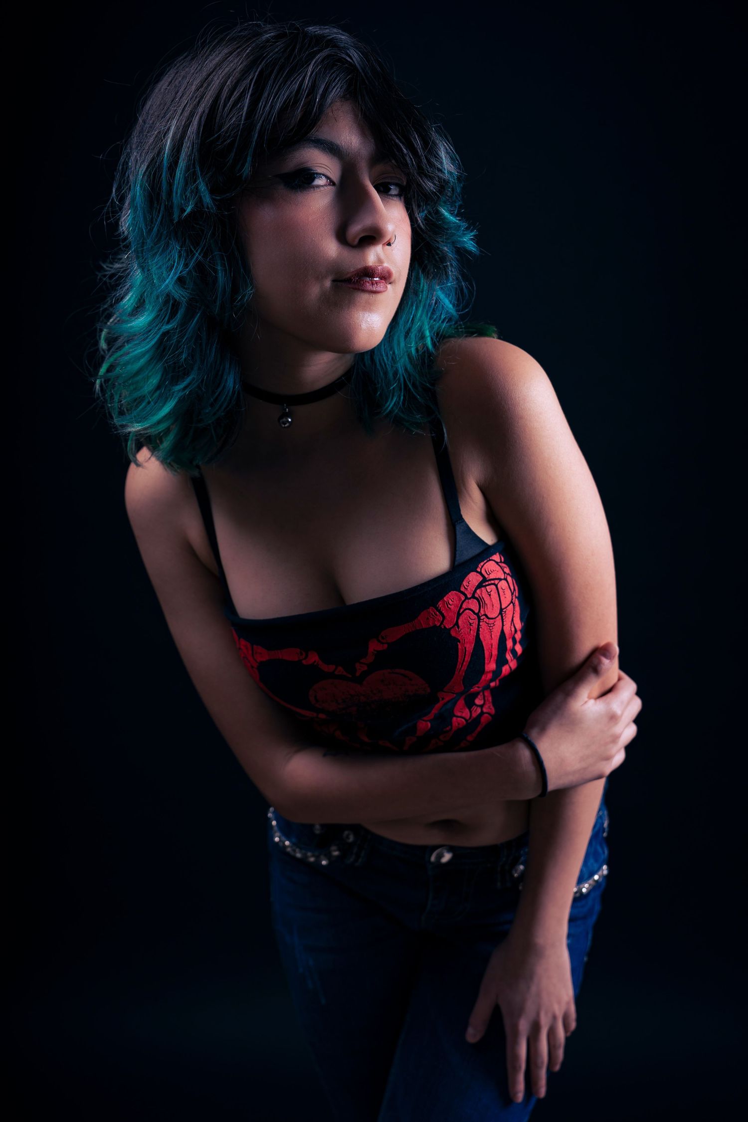A dramatic portrait series featuring a person with blue hair wearing a red top against a dark background.