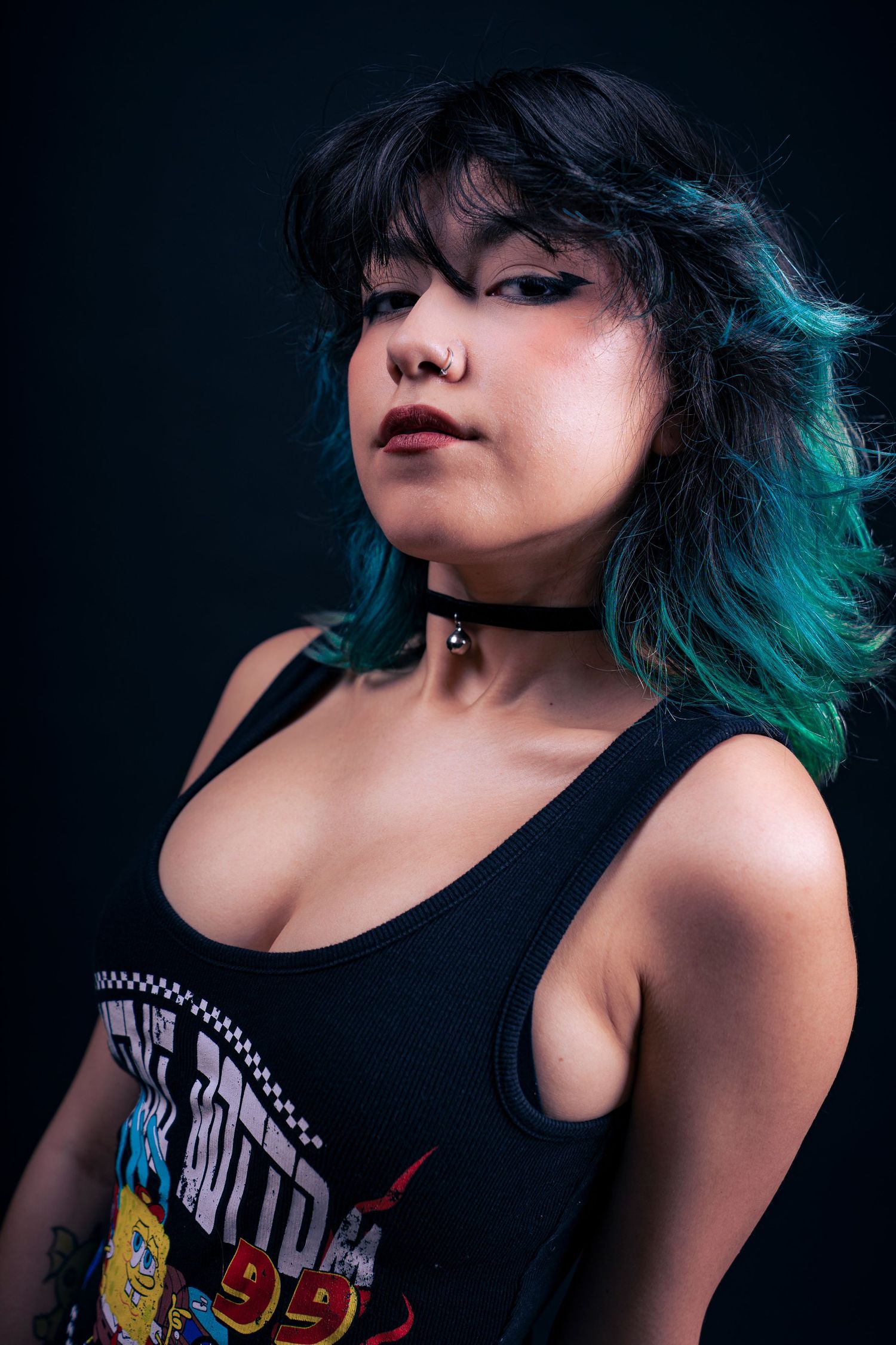 Artistic portrait series showing a person with blue-tinted hair wearing a black band t-shirt against a dark background.