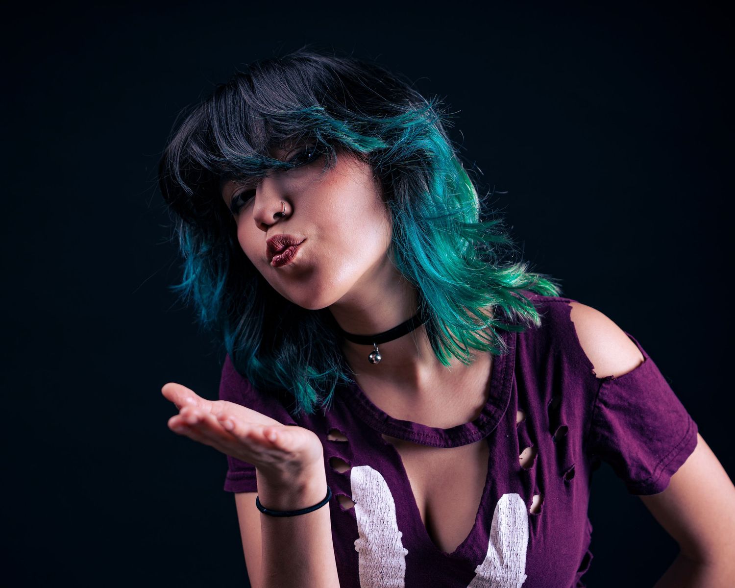 A creative photo sequence showing someone with turquoise hair blowing a kiss against a dark background.