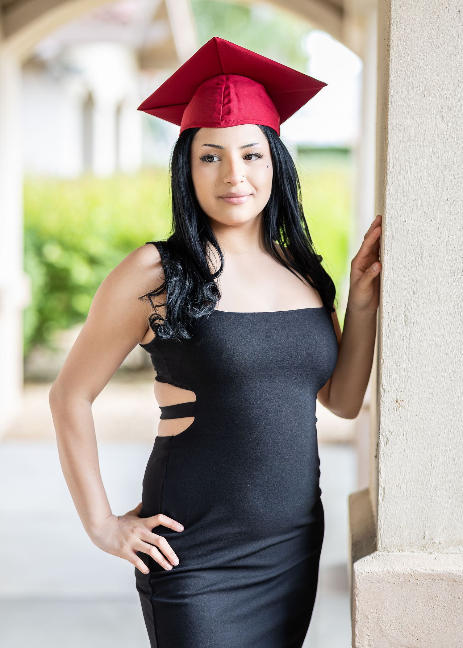 High School Senior Portraits. Female poses for her Senior Photos. Photographer uses natural lighting to photograph senior portrait.