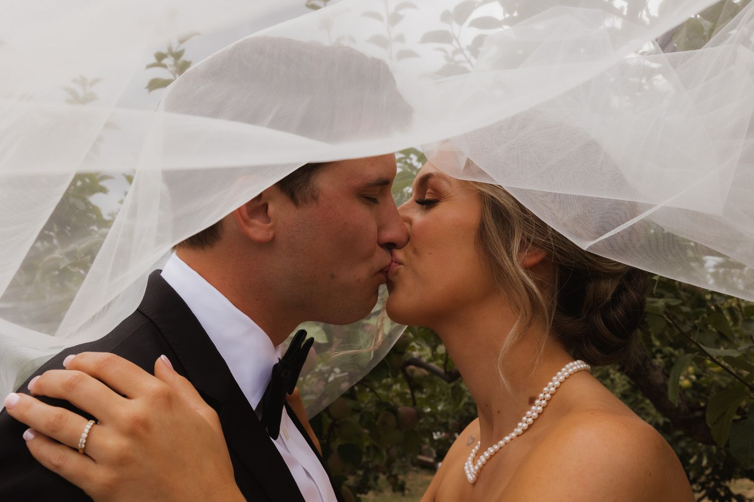 An intimate wedding moment shared under a flowing veil. Spokane wedding photographer.