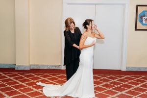 A special moment captured during wedding preparations in an elegant hotel room.