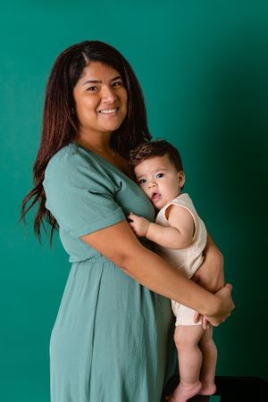 six month old boy hugging mom for milestone session