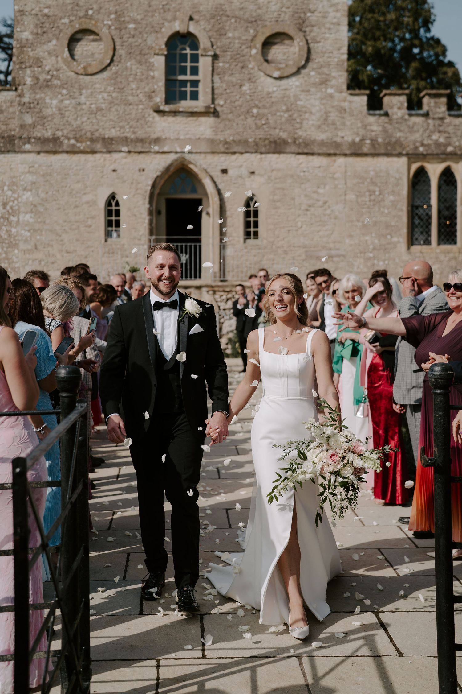 confetti throw over bride and groom at ivy lodge wedding in cirencester
