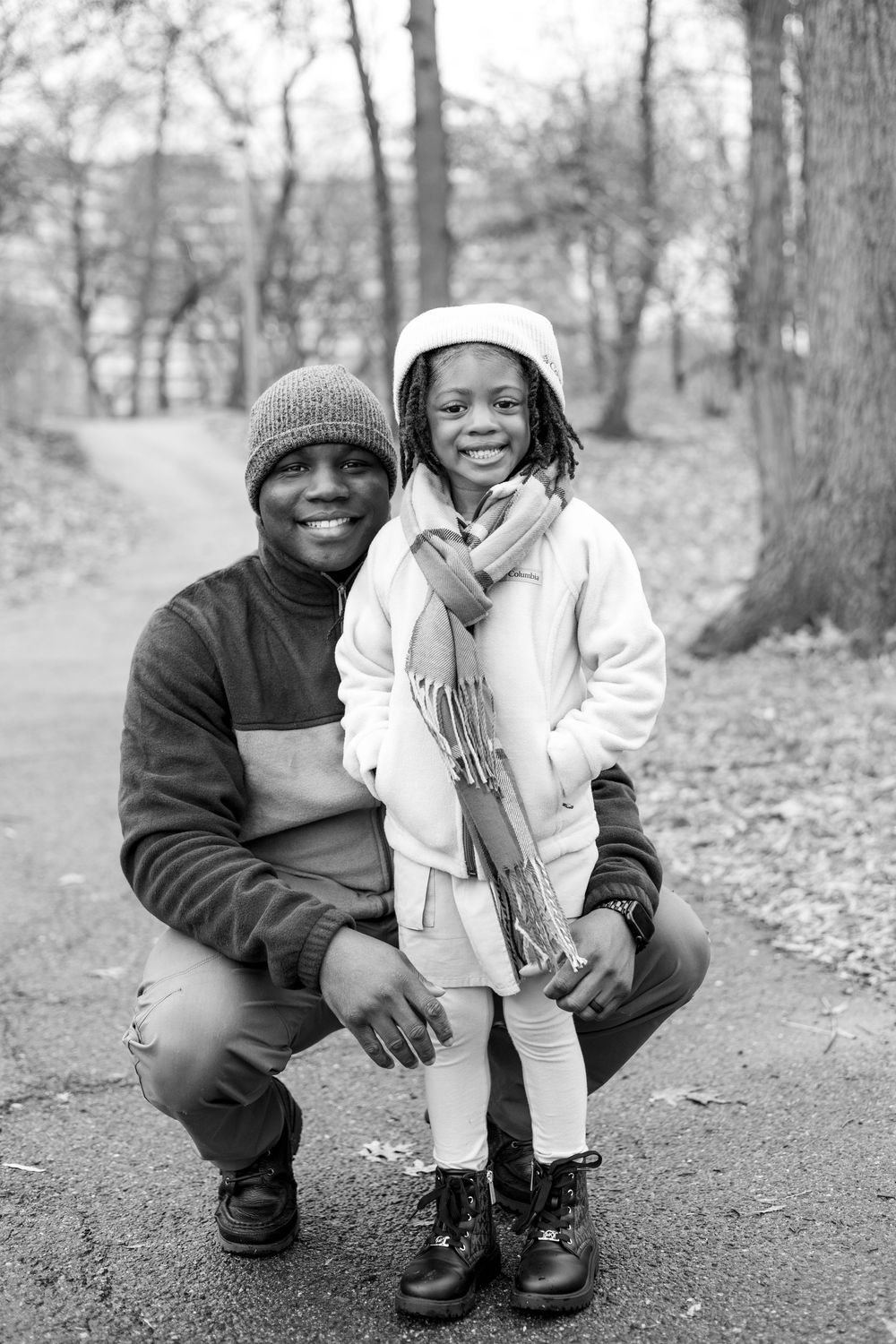 Black and white photo series showing candid moments of a parent and child crouching together outdoors.