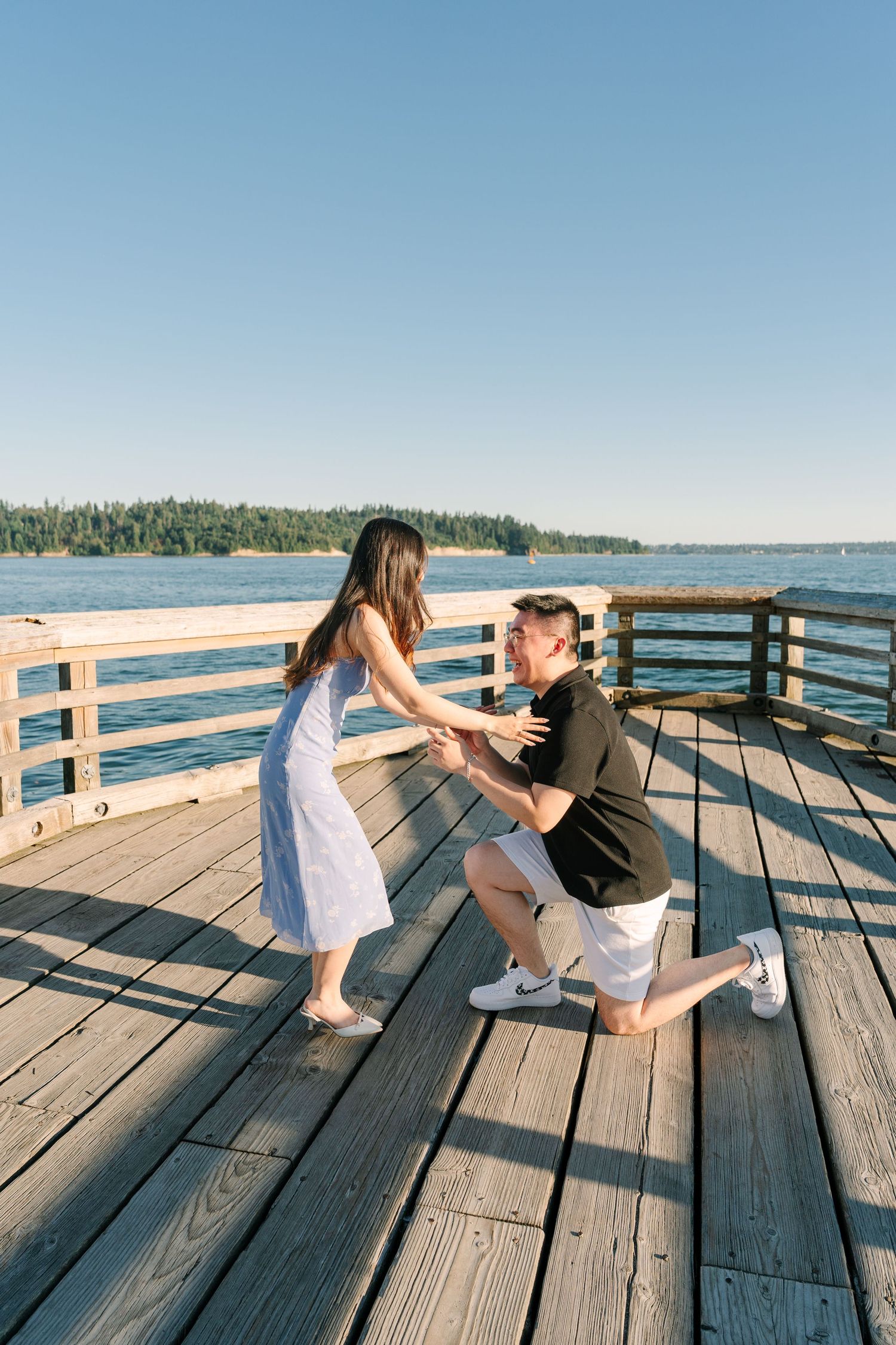A sequence of playful moments captured on a wooden pier overlooking a scenic lake on a sunny summer day.