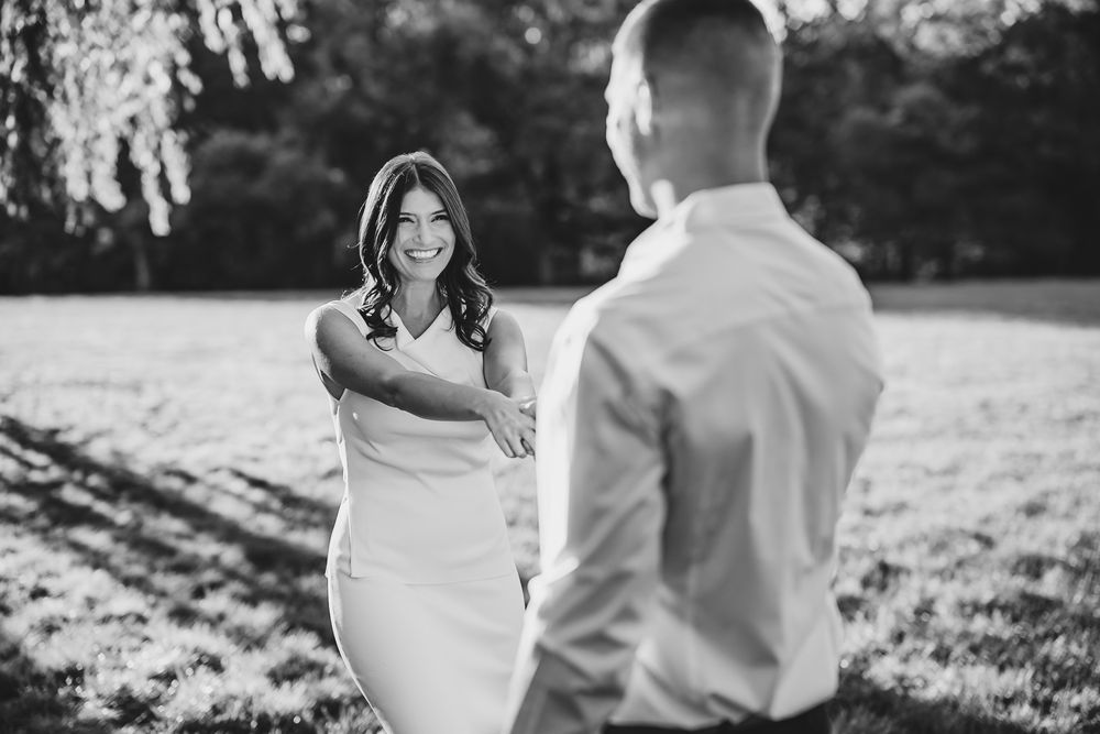 Candid moments captured in black and white beneath garden trees.