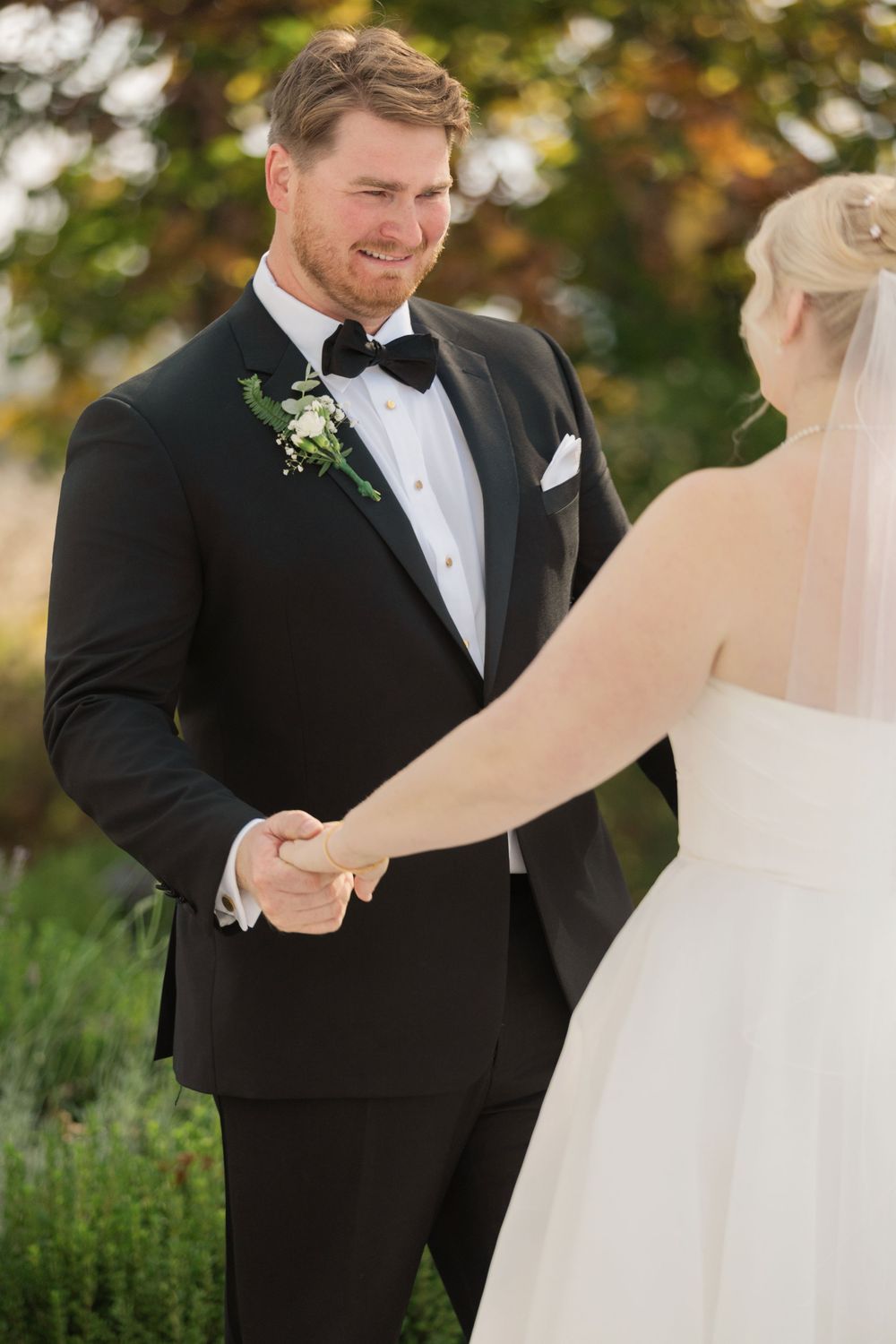 A couple shares a tender moment during their outdoor wedding ceremony.