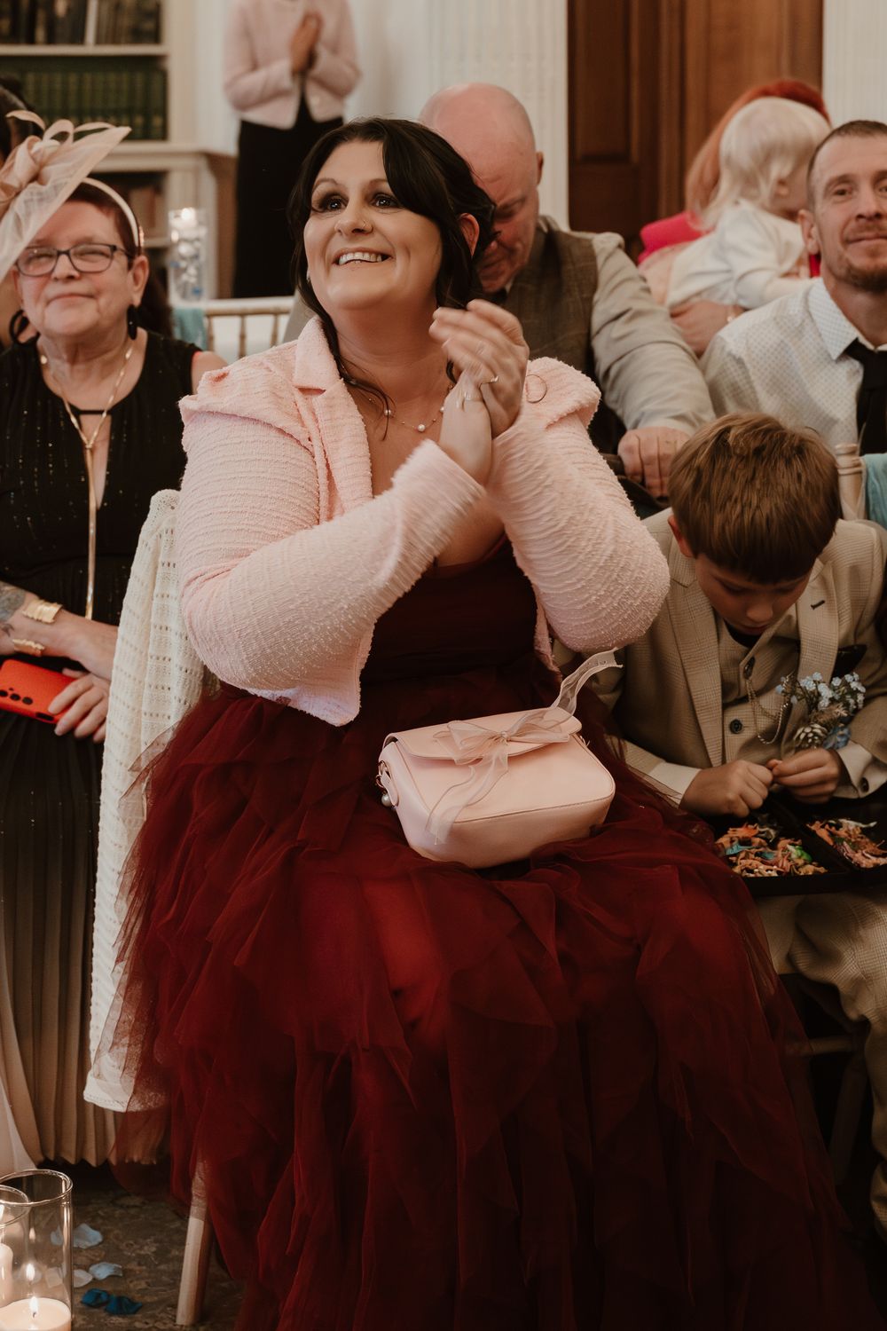 Wortley Hall - Wedding guests share an emotional embrace during a heartfelt reception moment.