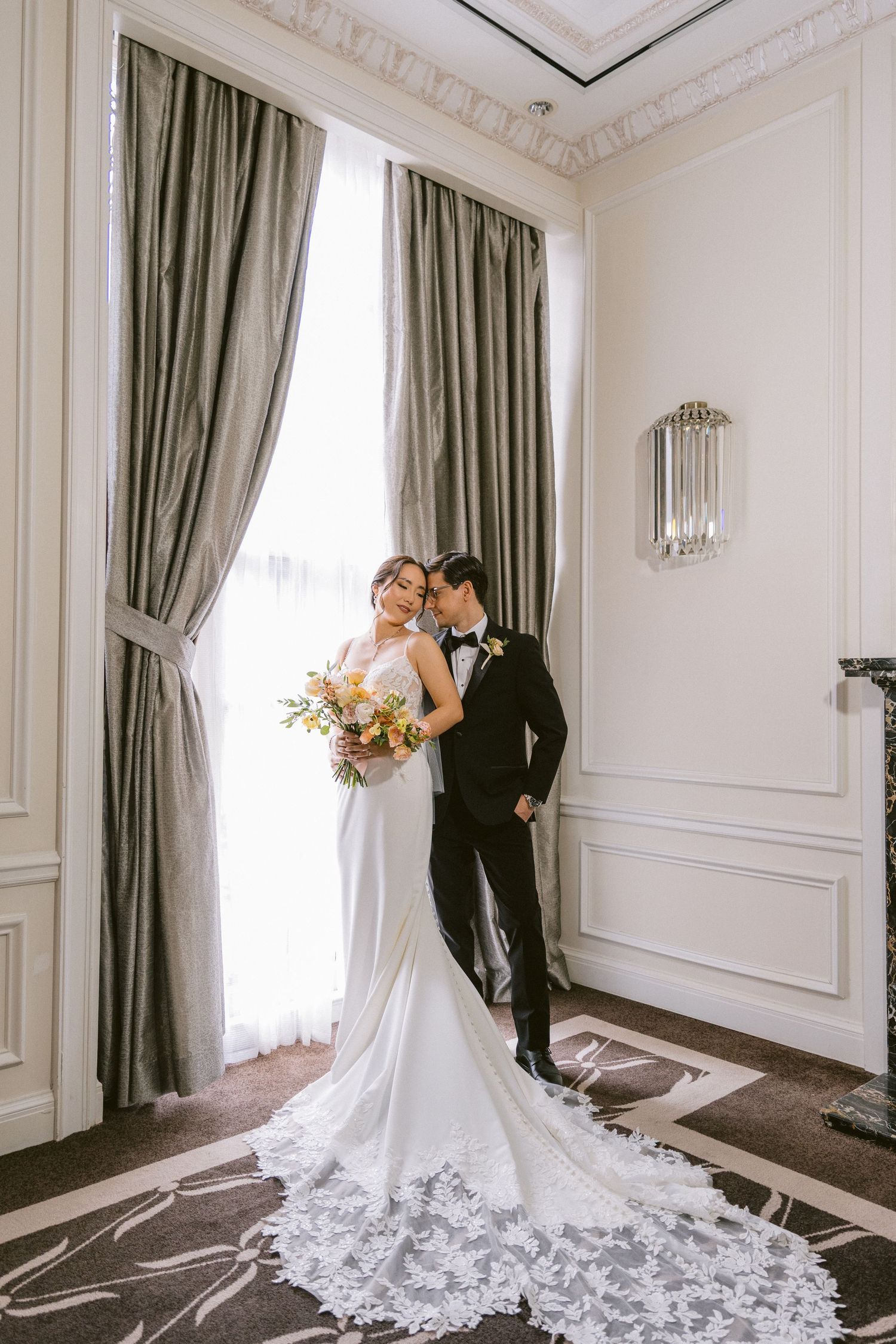A couple walks through a tunnel-like archway in formal wedding attire, captured in multiple black and white photos.