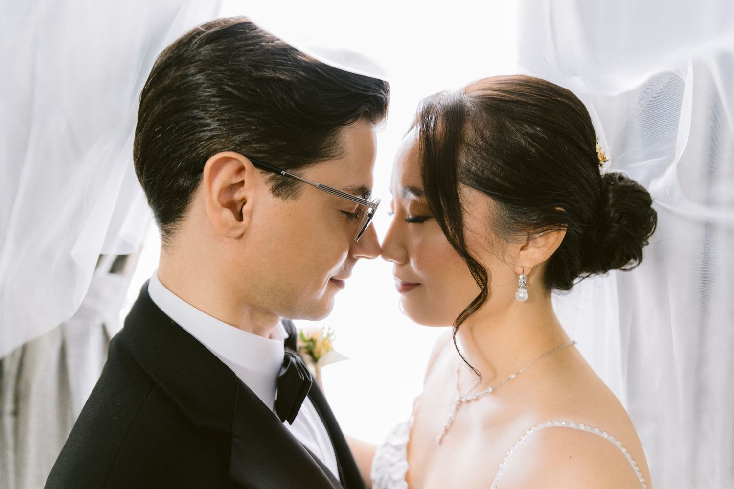 Bride and groom share intimate moments in a series of romantic black and white wedding portraits.