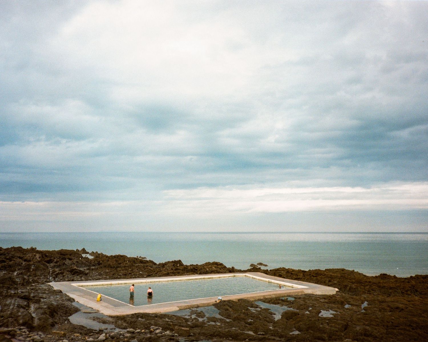 Panoramic coastal landscape with concrete platform overlooking a sandy beach. Westward Ho!