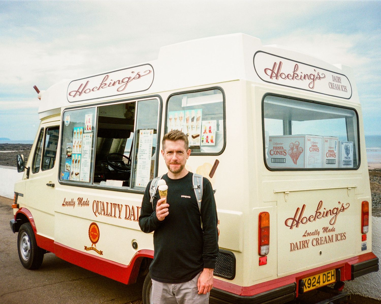 Vintage ice cream trucks parked along a coastal road. Westward Ho!