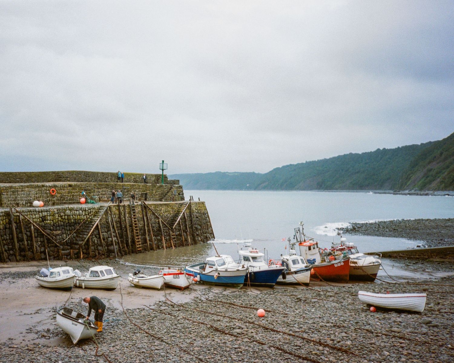 Row of fishing boats moored at a coastal harbor during low tide Lynmouth.