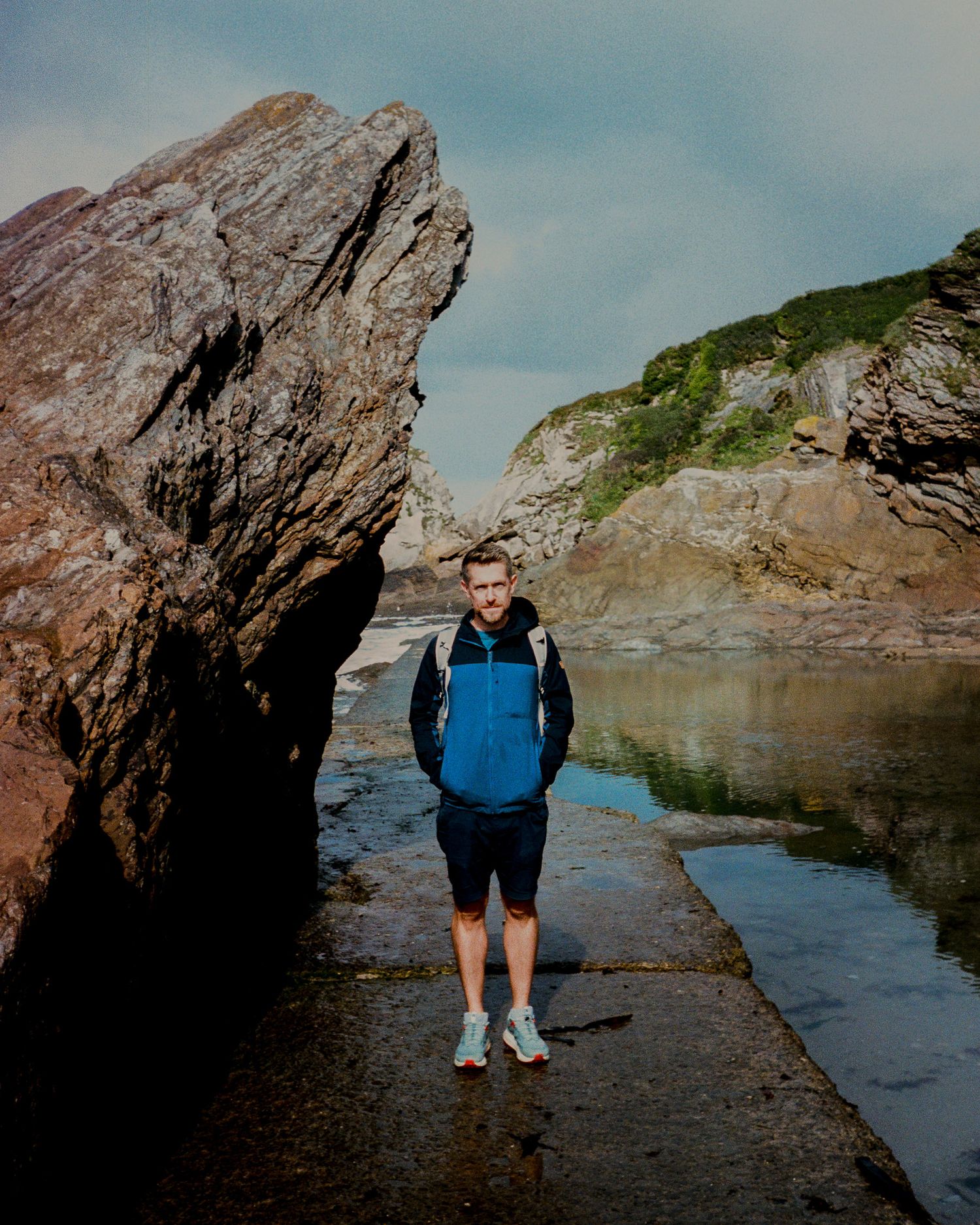 Rocky coastal formation creating natural pools by the ocean.