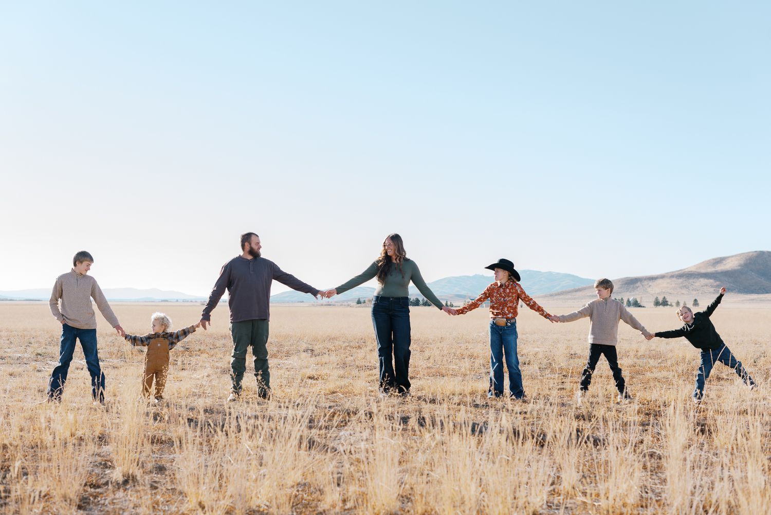 family photos of a rancher with mountains behind