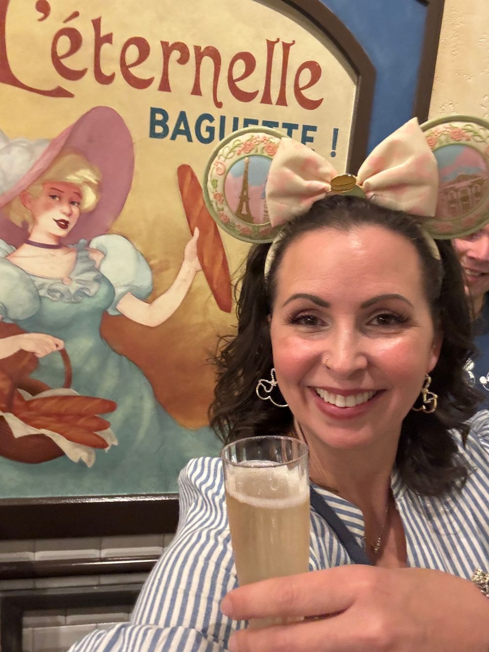 A series of photos showing someone enjoying drinks at a restaurant with vintage French advertising posters on the wall.