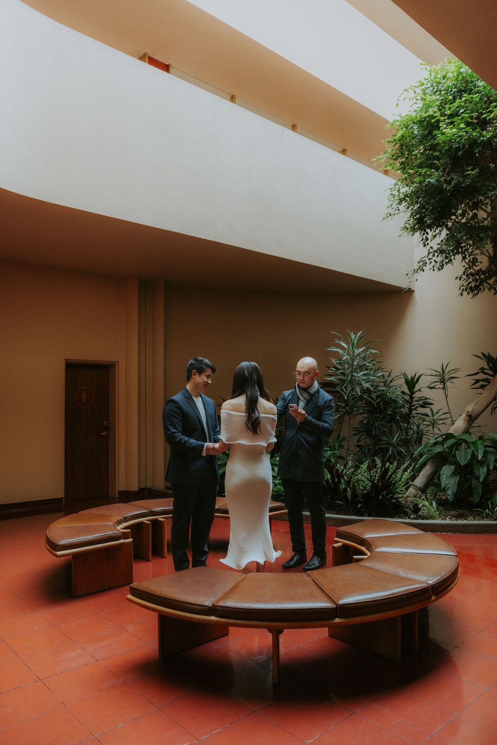 A sequence of photos showing people gathered around a curved concrete bench in a modern courtyard setting.