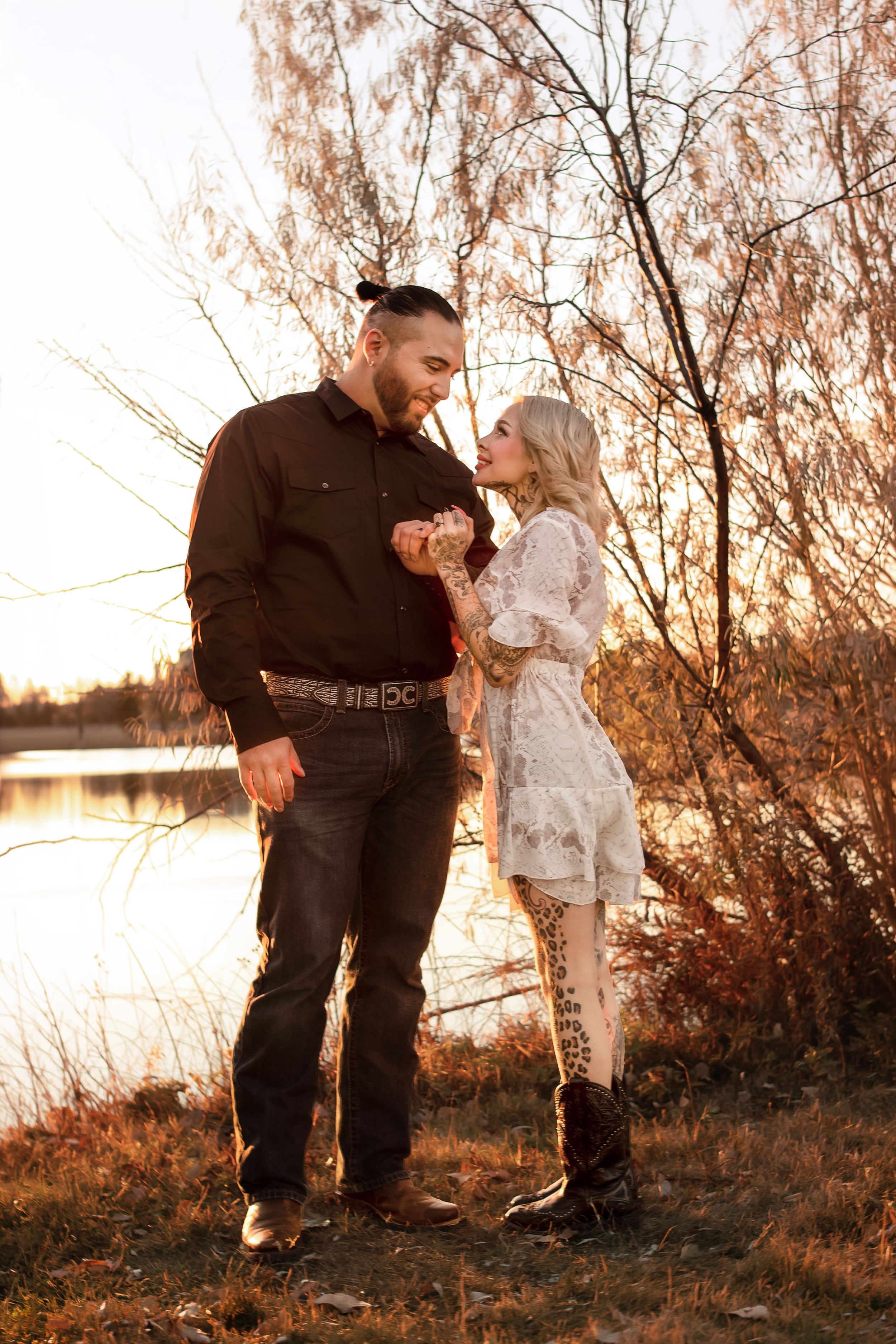 A parent and small child share tender moments in golden sunset light by a lake, captured in multiple candid shots in Williston, North Dakota
