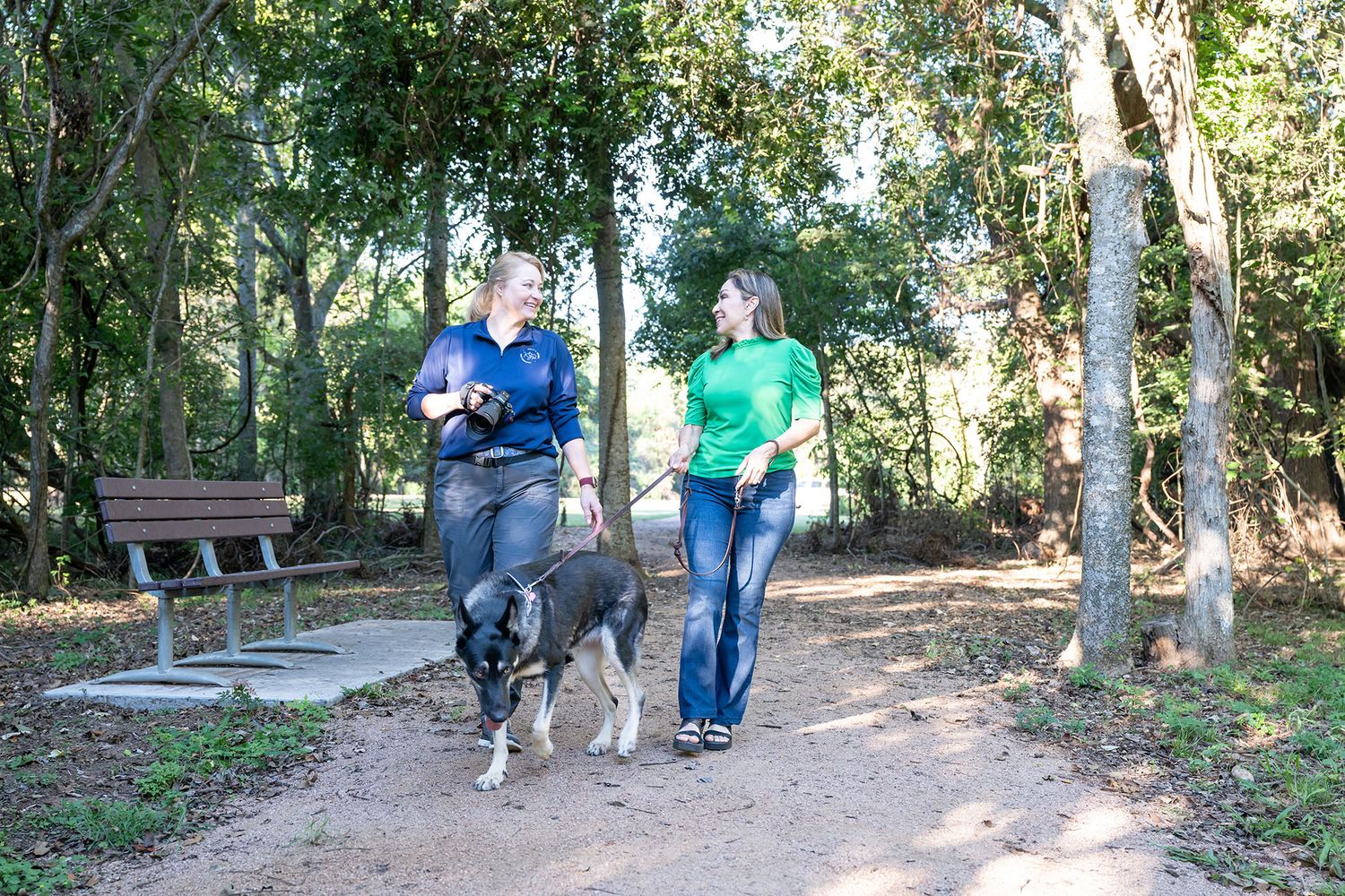 Houston pet photographer guiding dog owner through a comfortable and fear-free photo session outdoors