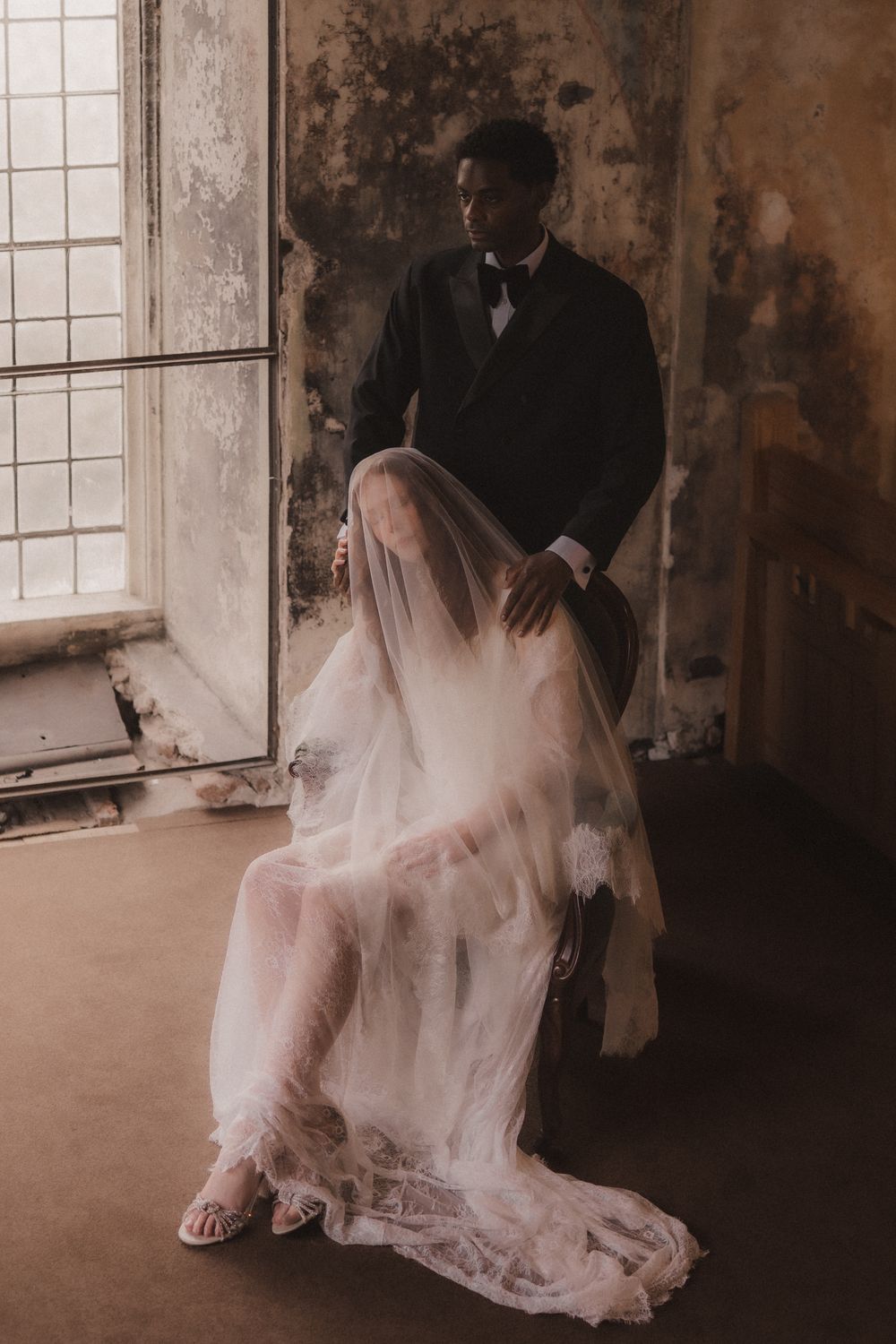 Artistic wedding photography series showing flowing white dress and veil details in a rustic indoor setting with natural light.
