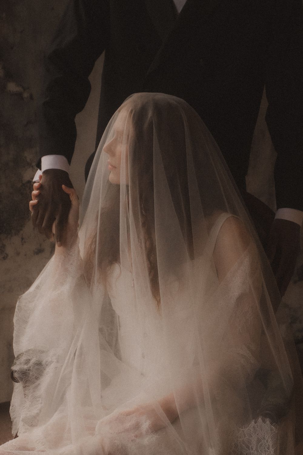 A series of ethereal bridal portraits showing flowing white veil and dress against a dark background.