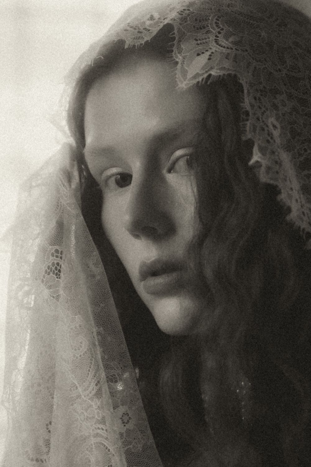 A haunting series of black and white portraits showing a figure in a lace veil with dramatic shadows and lighting.