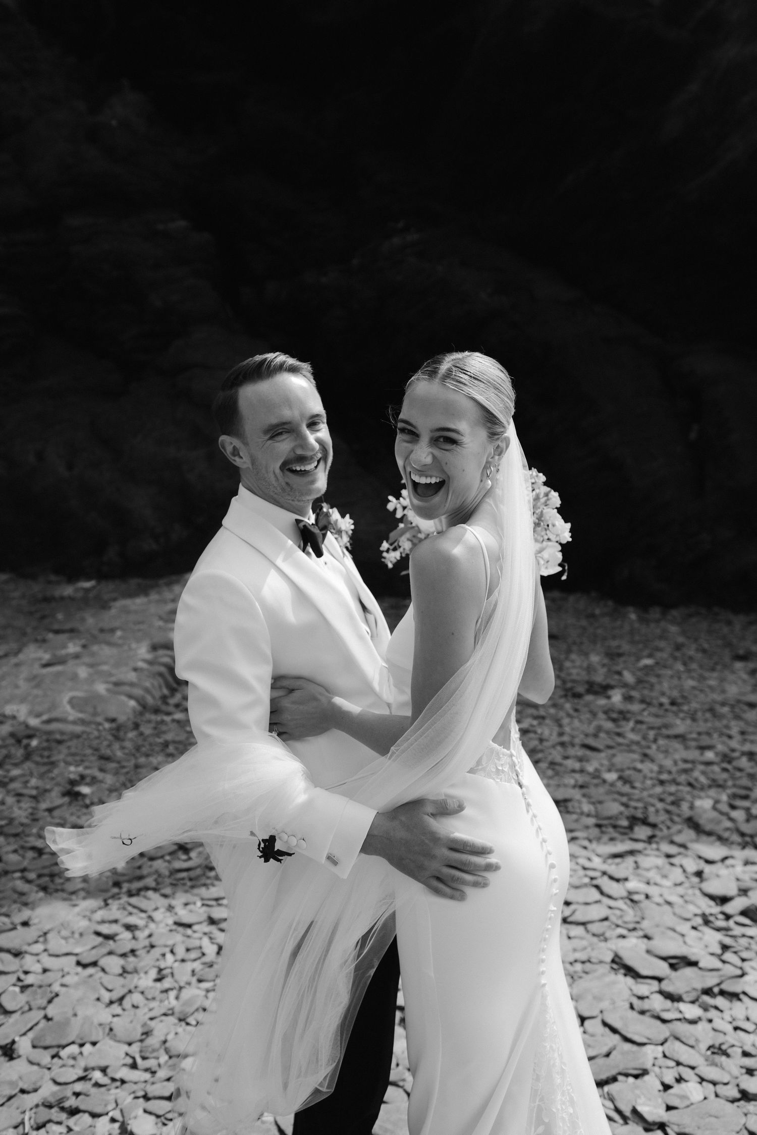 bride and groom on beach at tunnels beach in ilfracombe