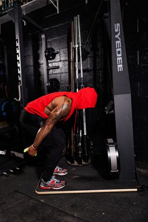 Step-by-step sequence showing proper form for bent-over rows exercise in a dark gym setting.