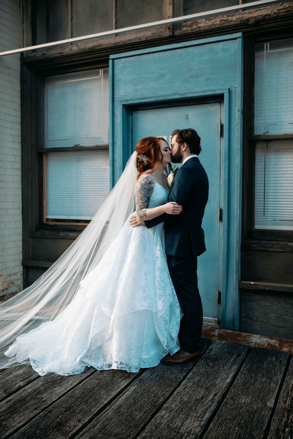 Bride and groom kissing in industrial Milwaukee setting.