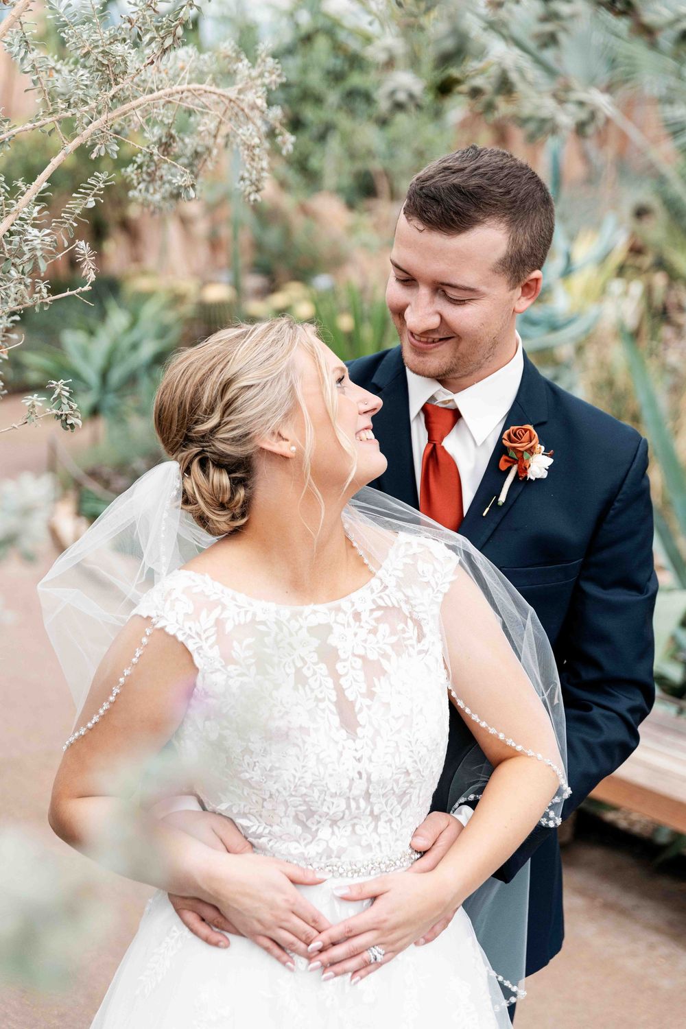 Bride and groom looking at each other during wedding portrait session at the Mitchell Park Domes.