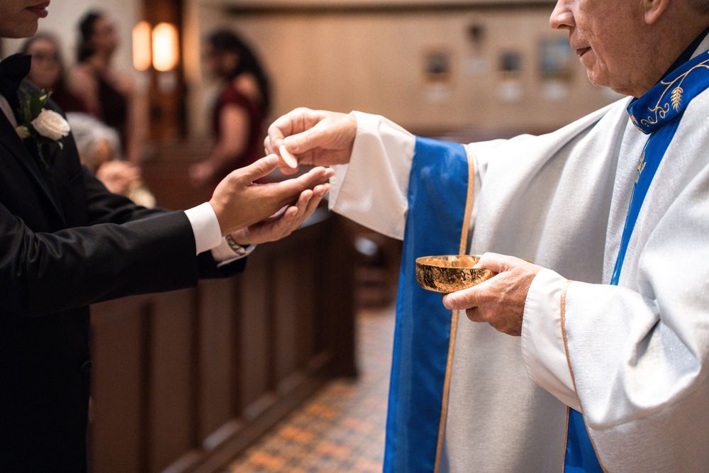 A series of hands holding communion wafers during a religious ceremony.