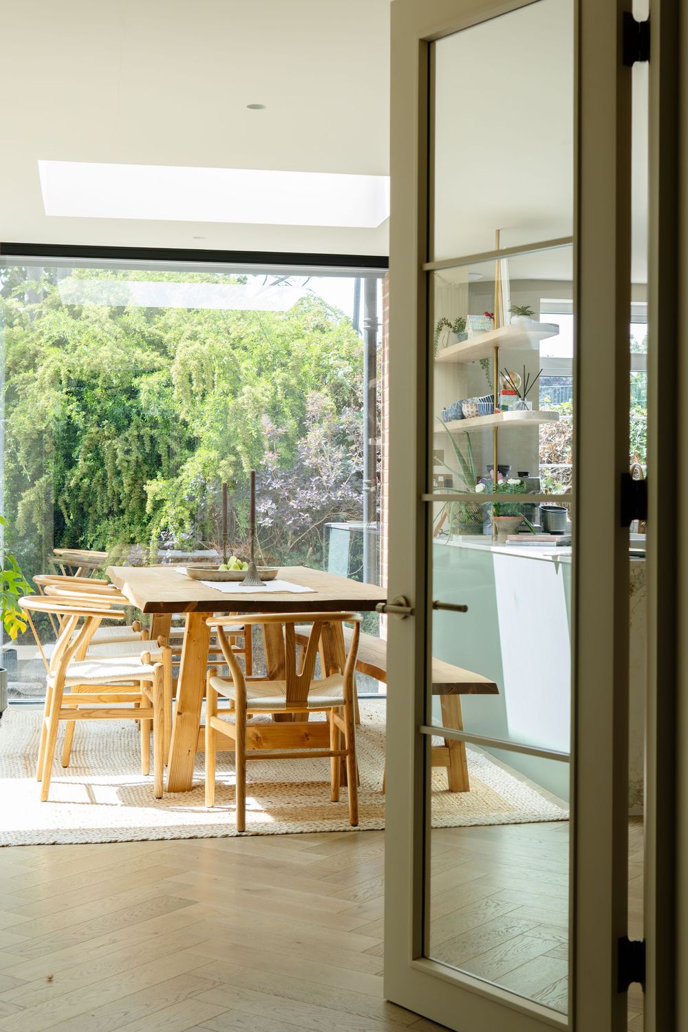Light-filled open-plan living space, featuring layered textures, soft neutral tones and thoughtful styling details