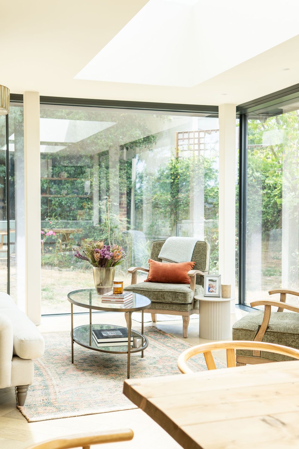 Light-filled open-plan living space, featuring layered textures, soft neutral tones and thoughtful styling details