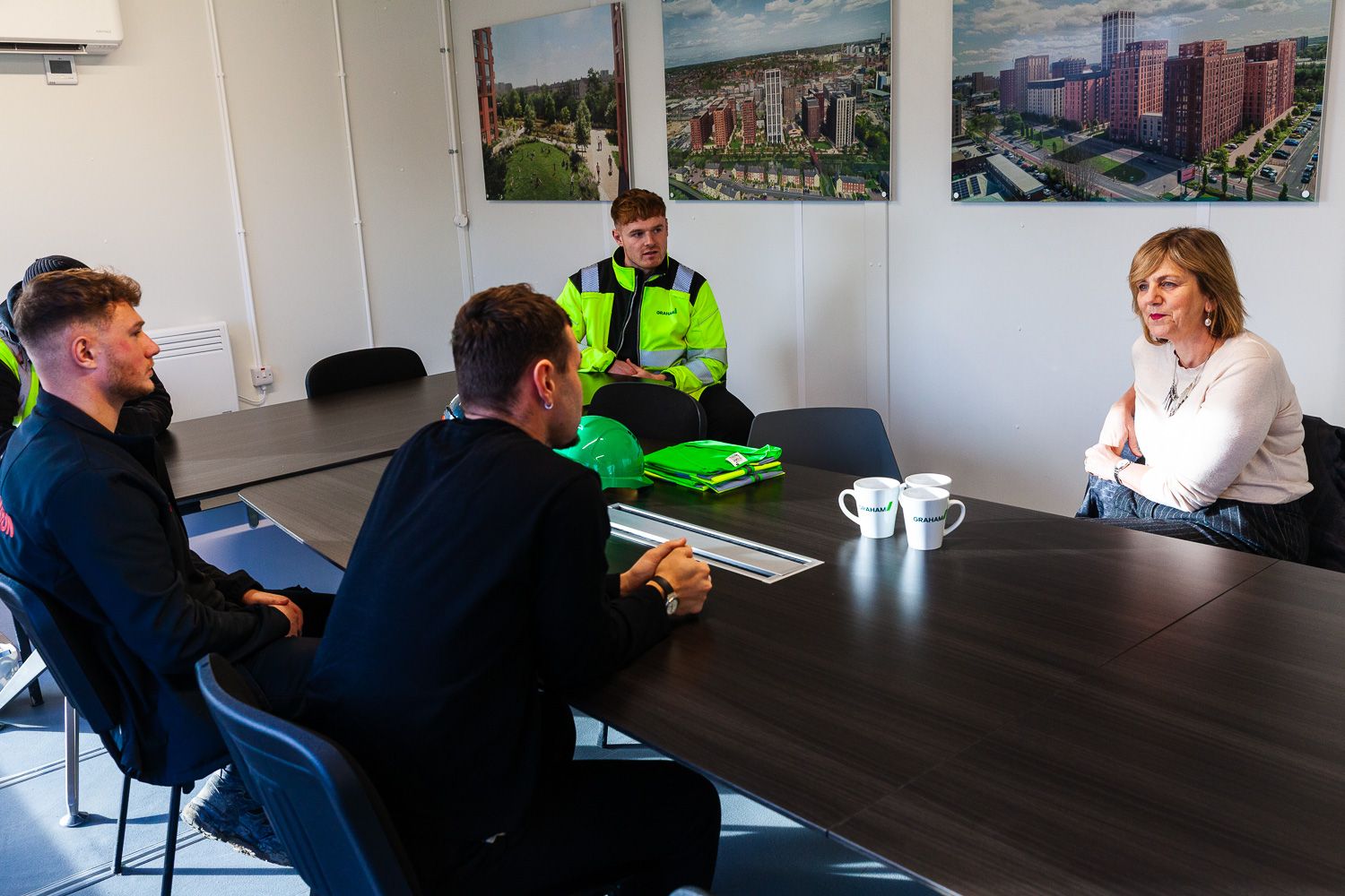 Photograph of local transport minister speaking with staff on visit to GRAHAM Dyecoats Leeds site